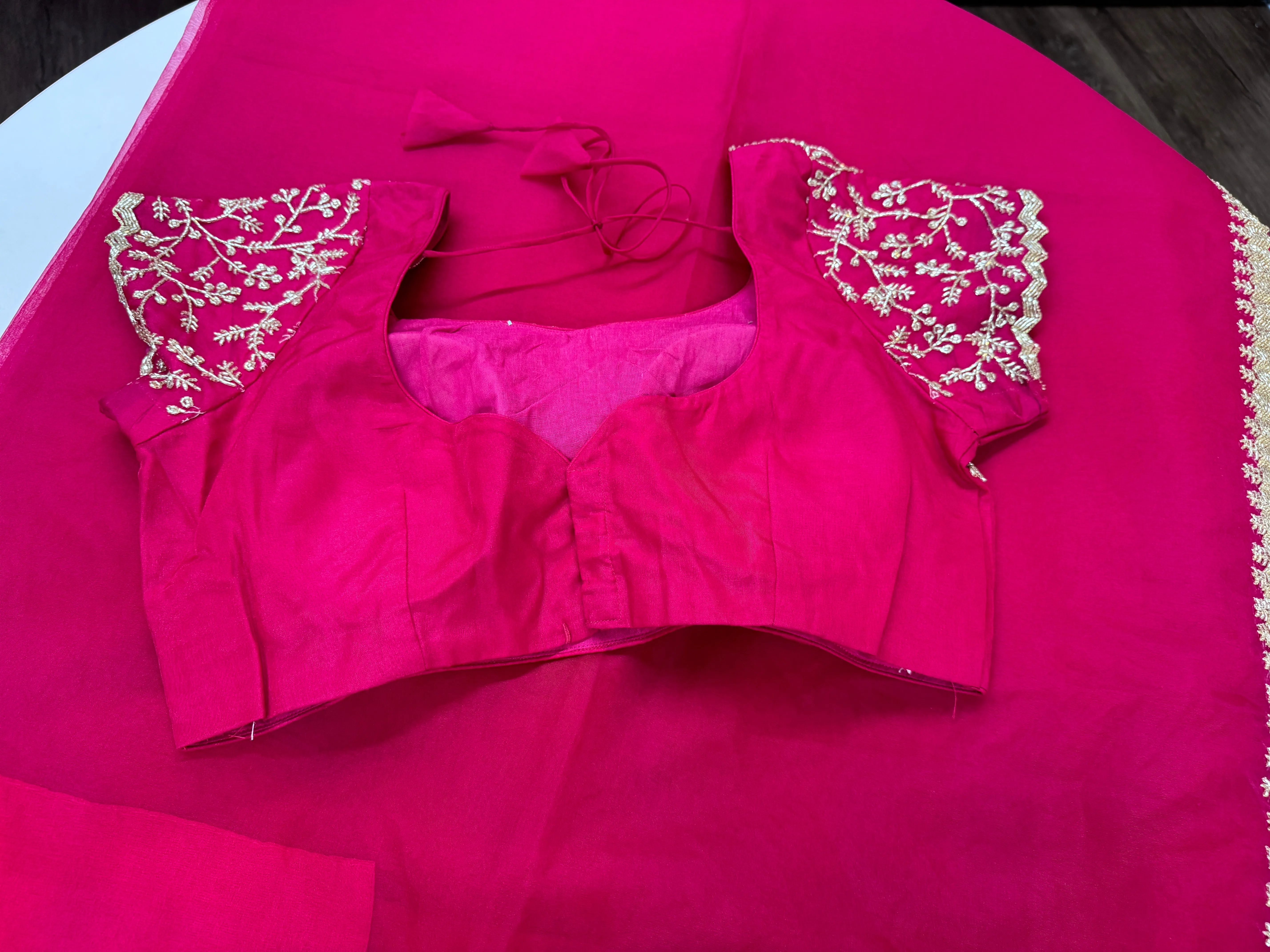 Rani pink embroidered Organza saree with stitched blouse