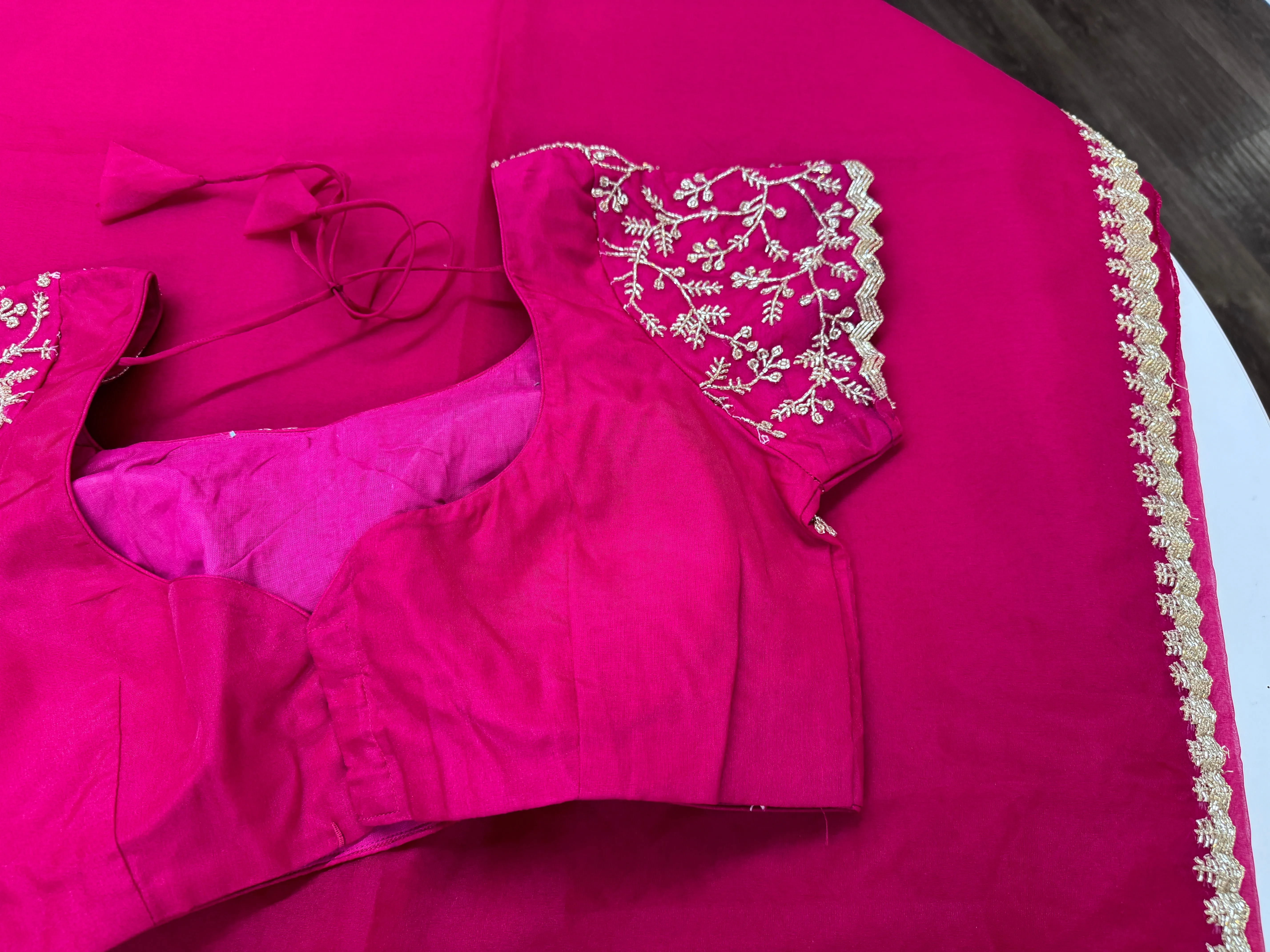 Rani pink embroidered Organza saree with stitched blouse