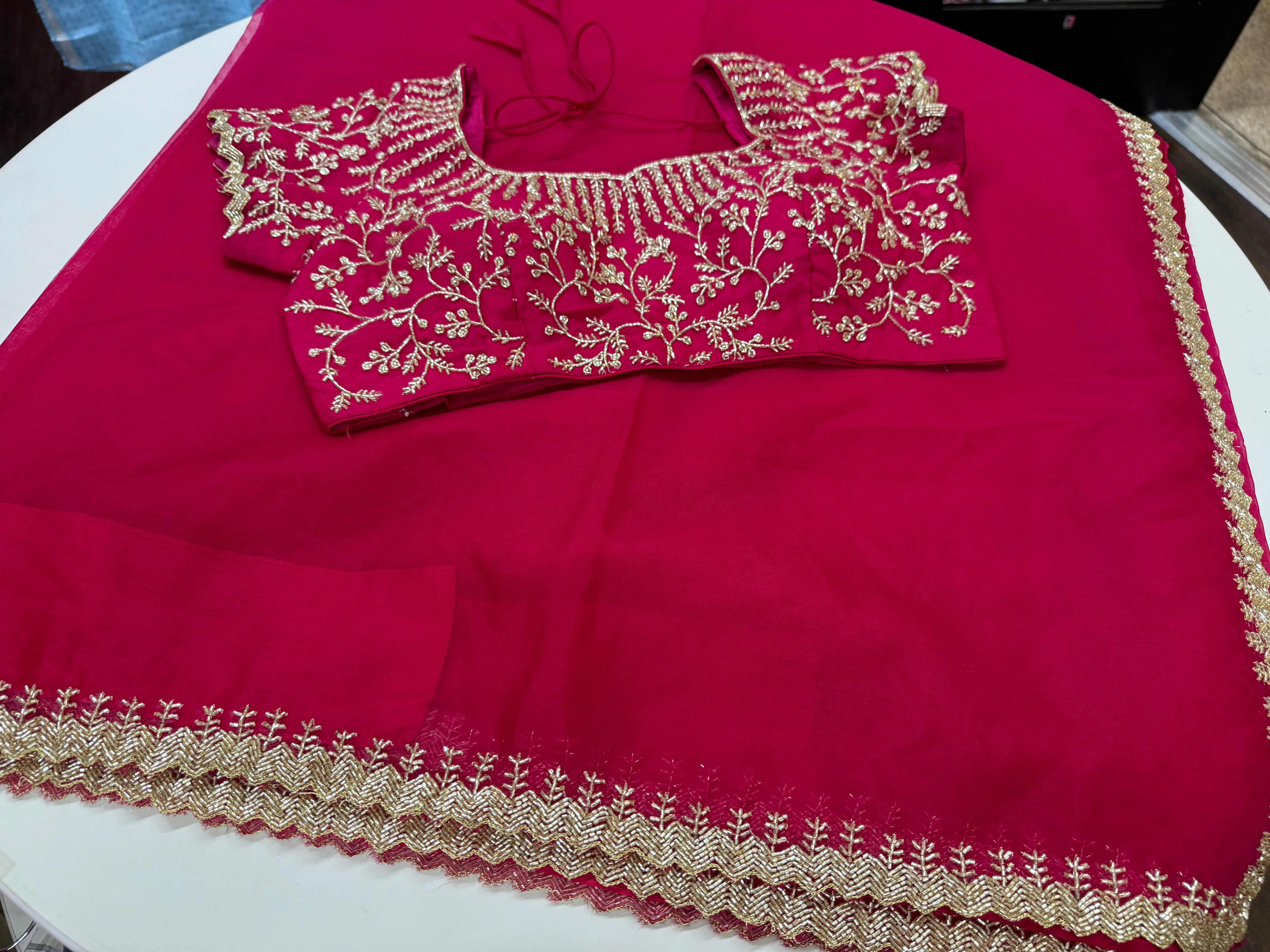 Rani pink embroidered Organza saree with stitched blouse