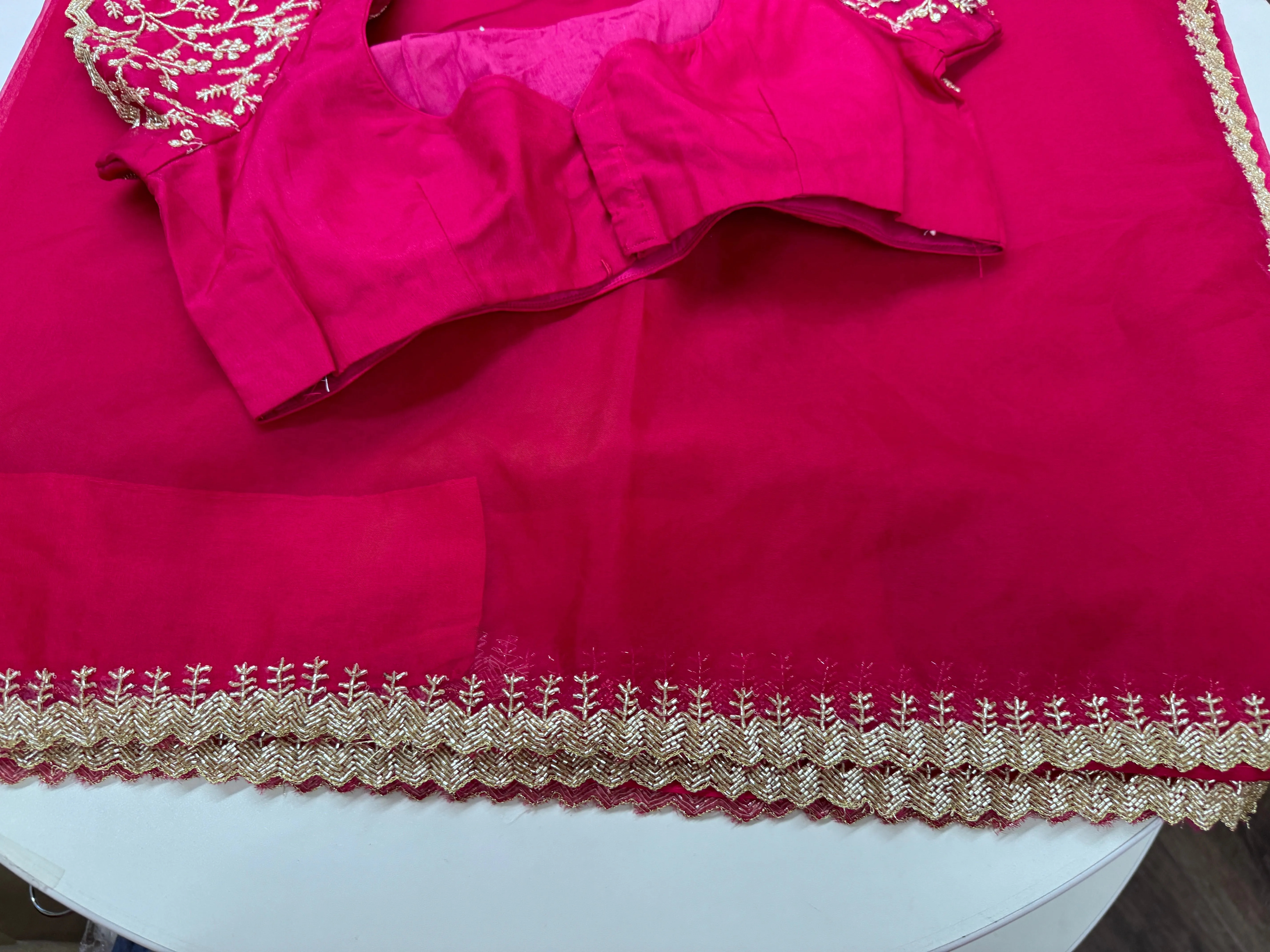 Rani pink embroidered Organza saree with stitched blouse