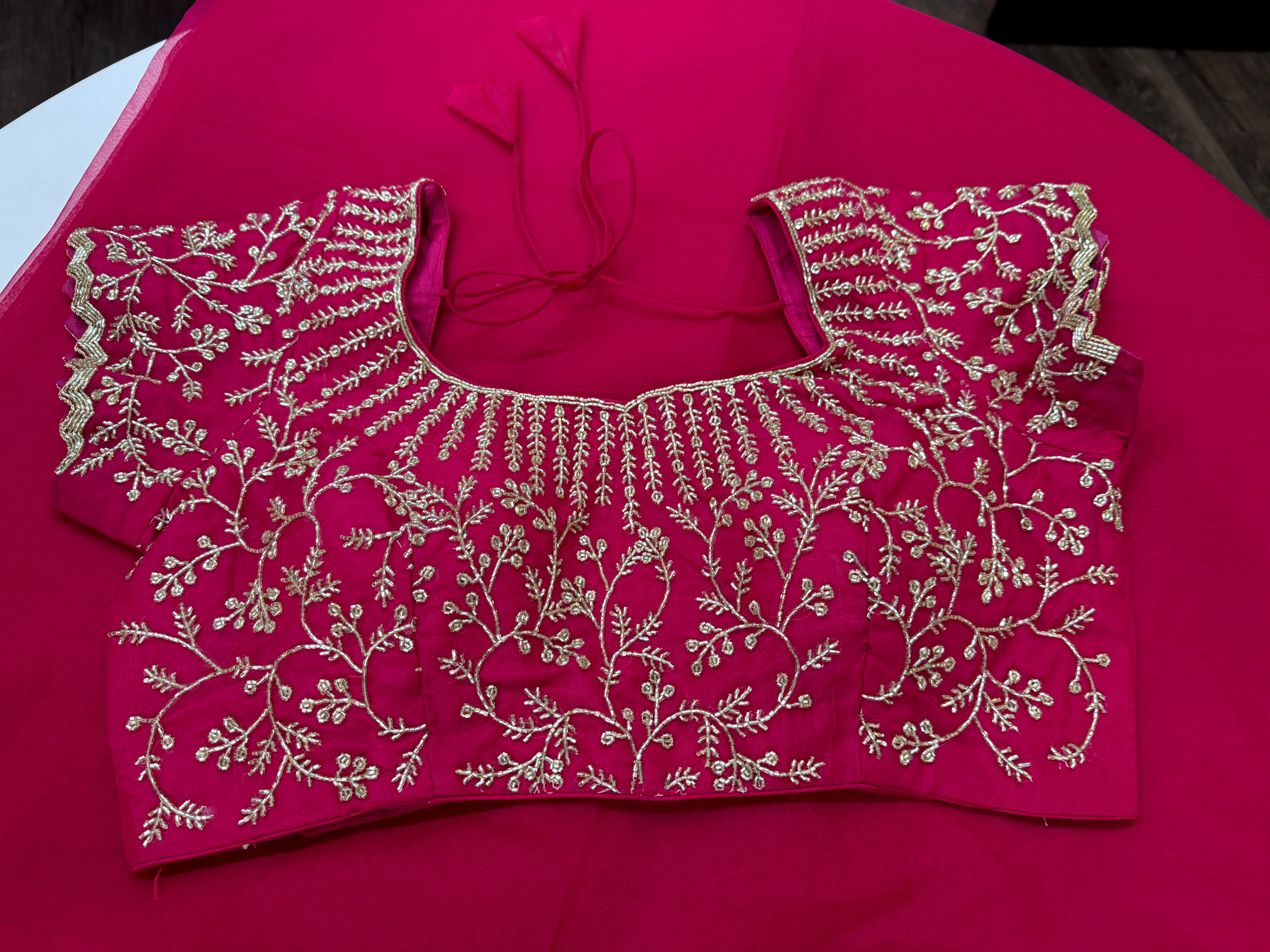 Rani pink embroidered Organza saree with stitched blouse