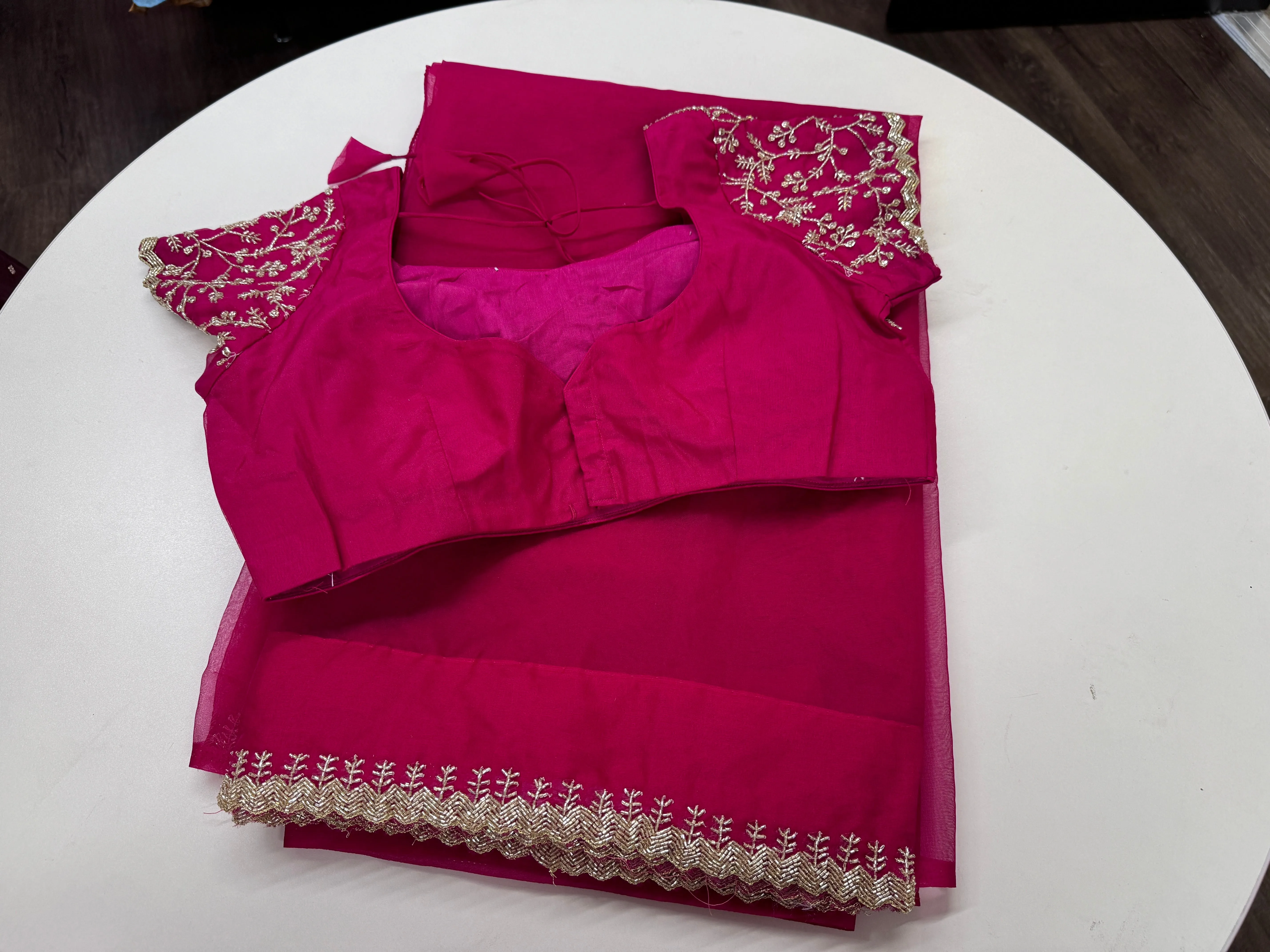 Rani pink embroidered Organza saree with stitched blouse
