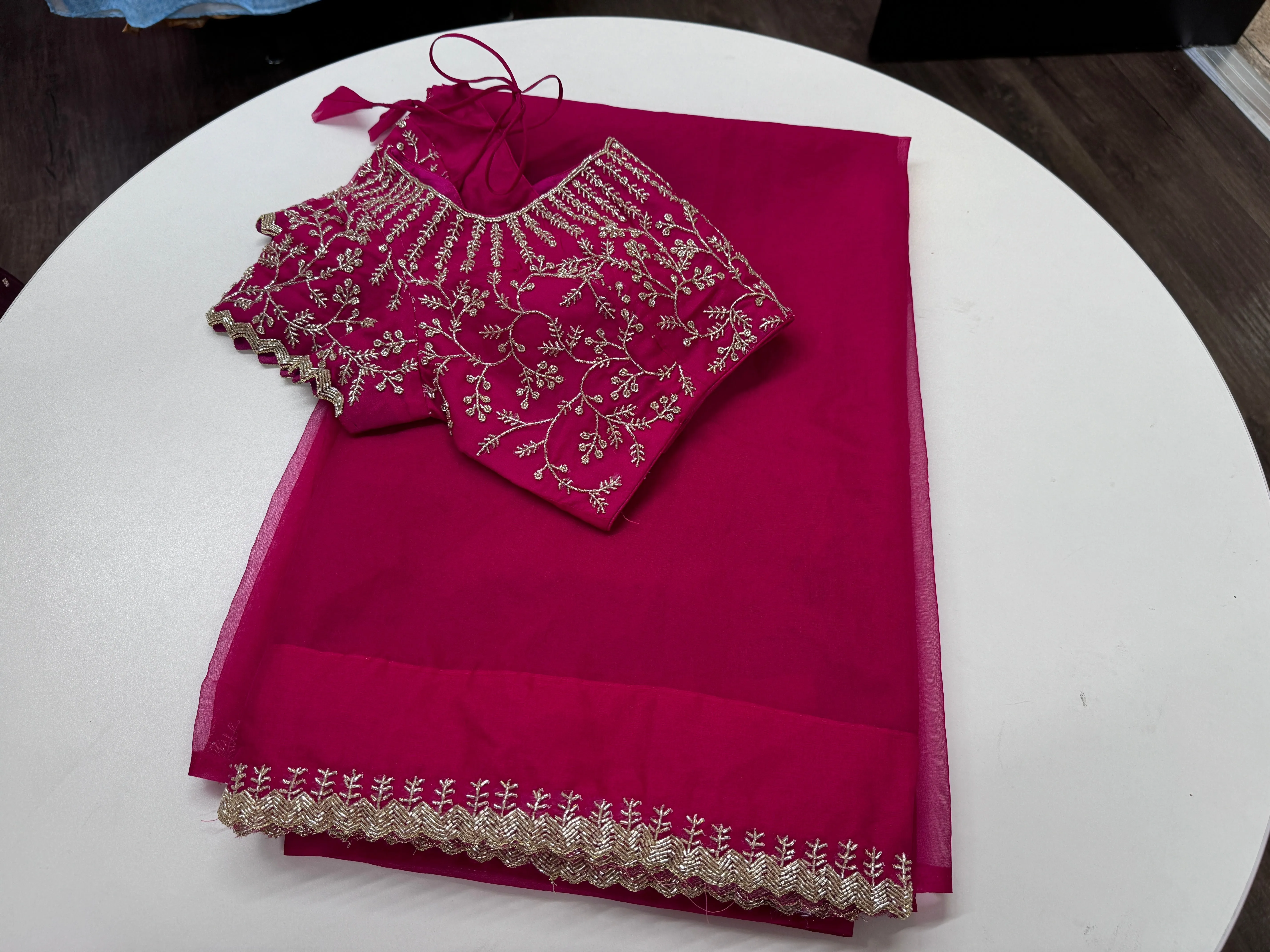Rani pink embroidered Organza saree with stitched blouse