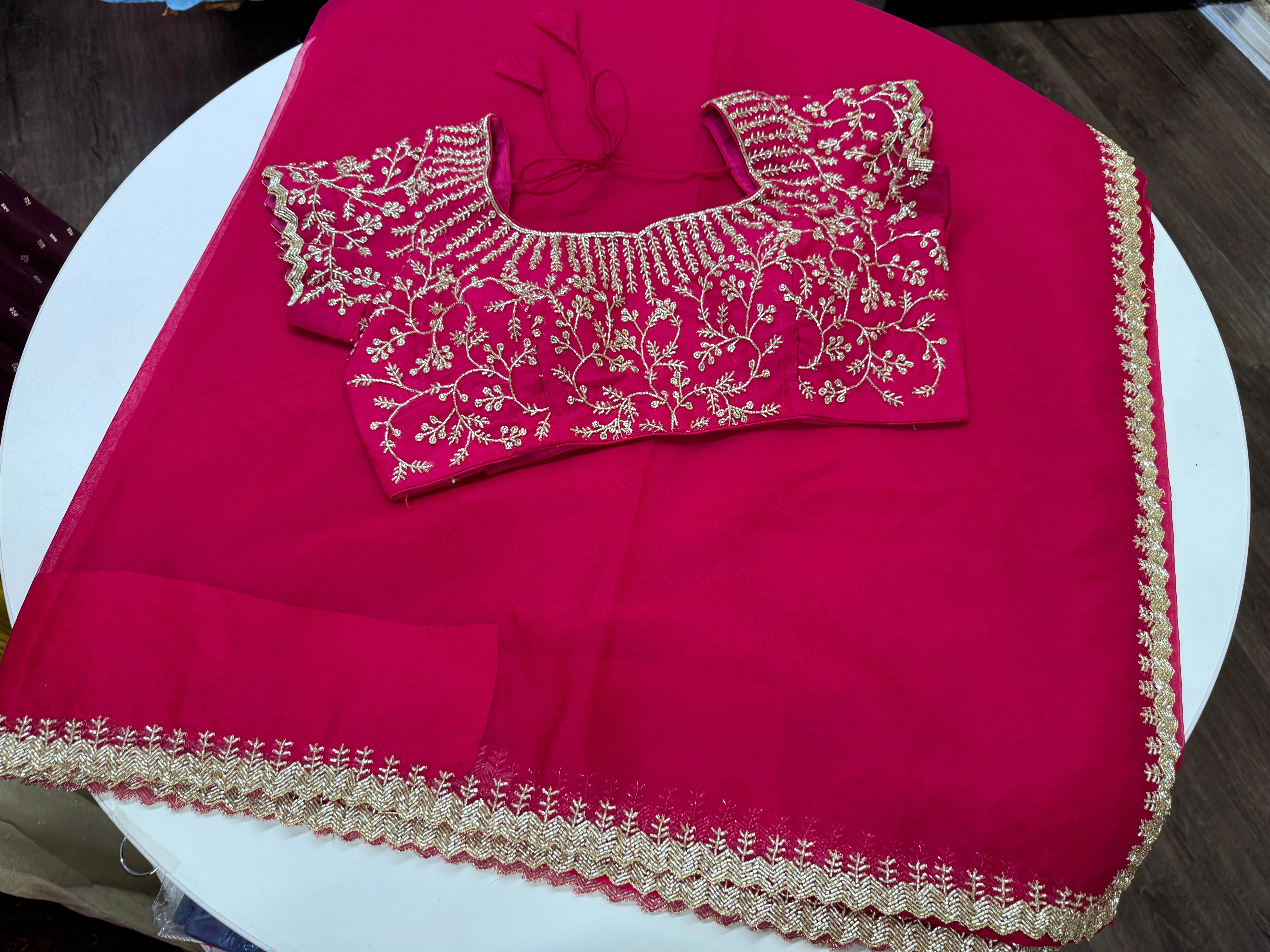 Rani pink embroidered Organza saree with stitched blouse